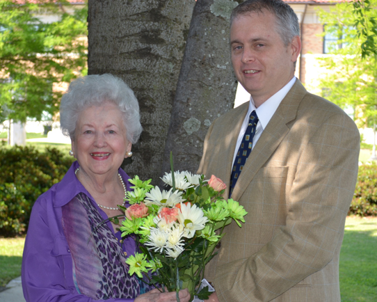 From left, Mrs. Jutta Karnstedt Ferretti accepts flowers from Dr. Mark Bonta, Associate Professor of Geography and Chair of the MA-LS Committee at Delta State, during a recent ceremony honoring the establishment of the John S. and Jutta Karnstedt Ferretti Fellowship.